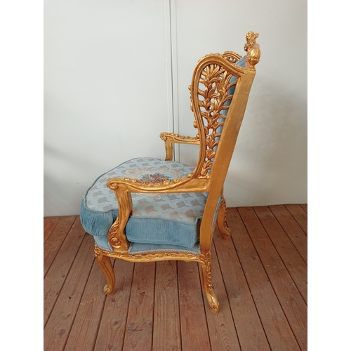 41 - A PAIR OF CONTINENTAL CARVED GILTWOOD AND UPHOLSTERED WING CHAIRS each with flowerhead and foliate c... 