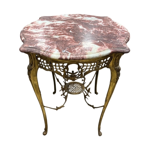 77 - A CONTINENTAL GILT BRASS AND MARBLE TABLE of serpentine outline surmounted by a veined marble top ab... 