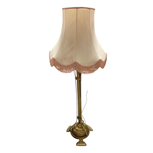 81 - A VINTAGE BRASS FLOOR STANDARD LAMP the cylindrical column above a circular embossed spreading foot ... 