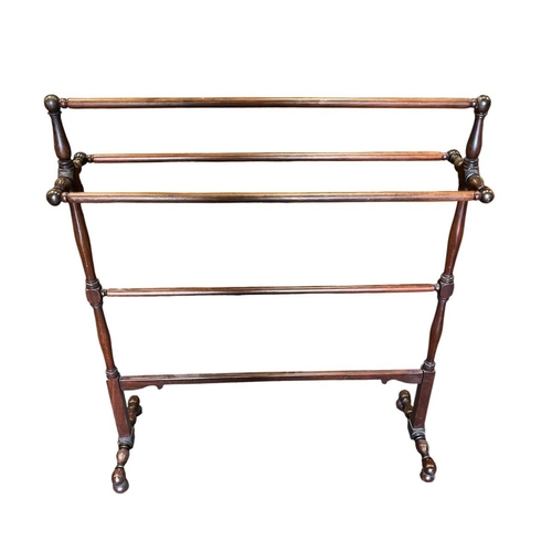87 - A 19TH CENTURY MAHOGANY FIVE BAR TOWEL RAIL with baluster and ring turned uprights on bun feet 94cm ... 