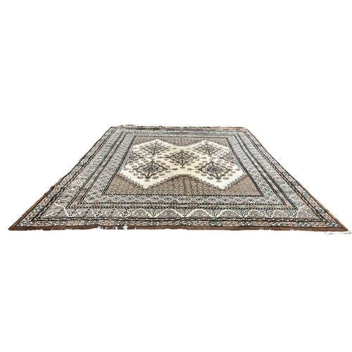 A KAIROUAN WOOL RUG the beige, light blue and tan ground with central ...