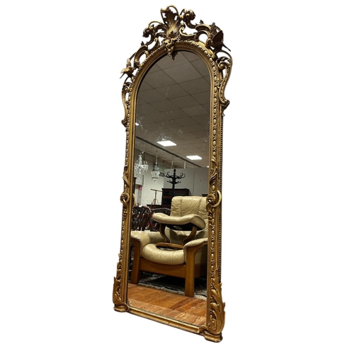 112 - A FINE 19TH CENTURY GILTWOOD AND GESSO MIRROR the rectangular arched plate within an egg and dart an... 