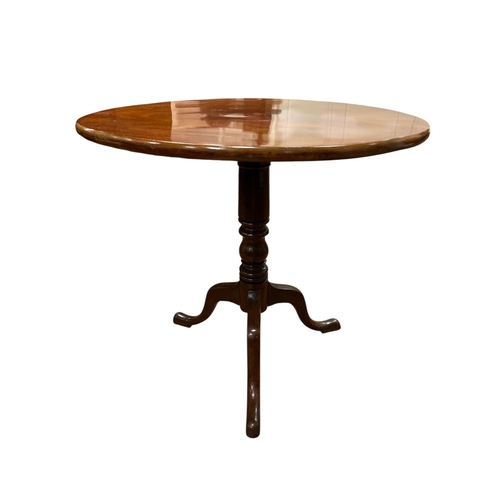 62 - A GEORGIAN MAHOGANY SNAP TOP TABLE the circular moulded top above a baluster column on tripod suppor... 