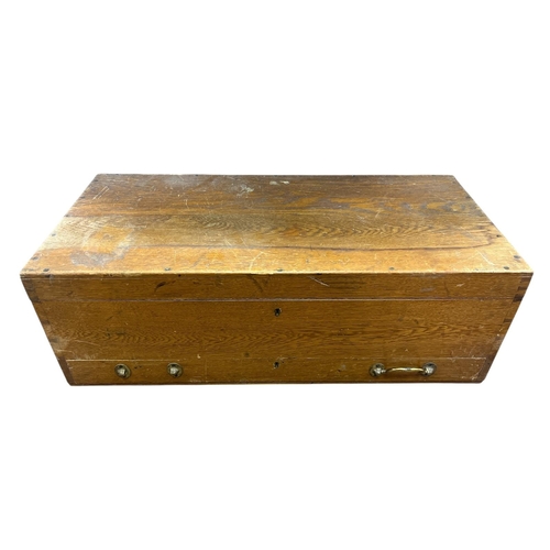 155 - A VINTAGE WOODEN CASE containing an assortment of railway track 0 gauge, etc.