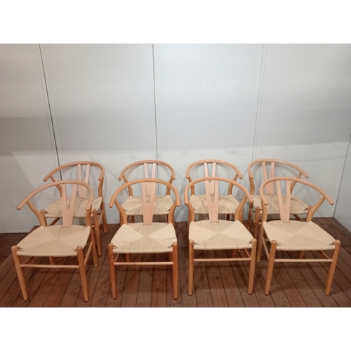 A SET OF EIGHT HANS J. WEGNER STYLE WISHBONE CHAIRS with woven ropework seats on cylindrical tapering legs