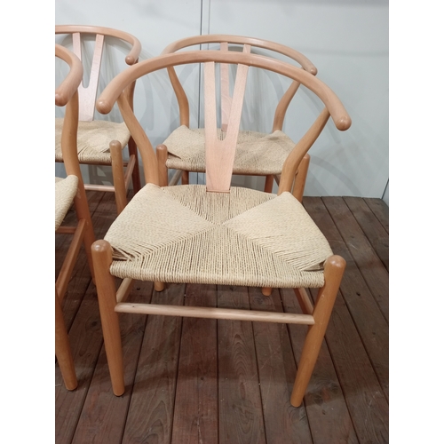 477 - A SET OF EIGHT HANS J. WEGNER STYLE WISHBONE CHAIRS with woven ropework seats on cylindrical taperin... 