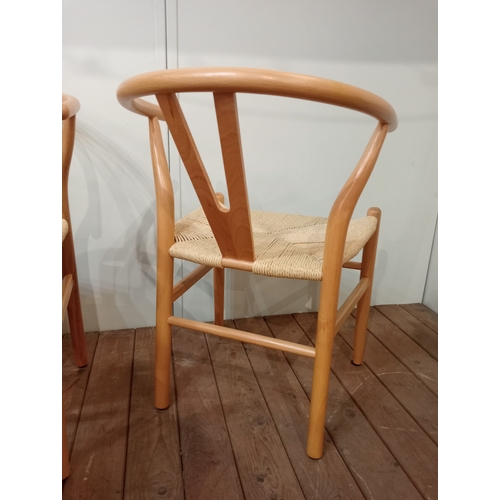 477 - A SET OF EIGHT HANS J. WEGNER STYLE WISHBONE CHAIRS with woven ropework seats on cylindrical taperin... 