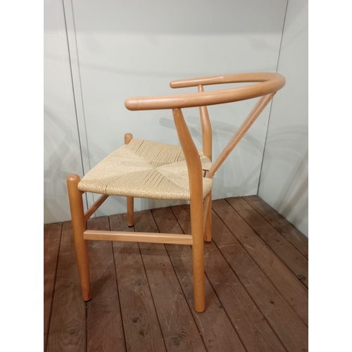 477 - A SET OF EIGHT HANS J. WEGNER STYLE WISHBONE CHAIRS with woven ropework seats on cylindrical taperin... 