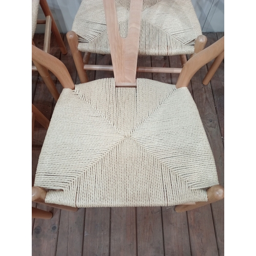 477 - A SET OF EIGHT HANS J. WEGNER STYLE WISHBONE CHAIRS with woven ropework seats on cylindrical taperin... 