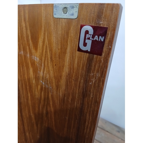 279 - A VINTAGE G-PLAN TEAK SIDEBOARD of rectangular outline the shaped top above four frieze drawers and ... 