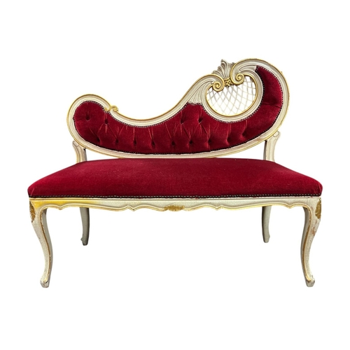 286 - A CONTINENTAL CREAM PAINTED PARCEL GILT AND UPHOLSTERED SETTEE the serpentine top rail with lattice ... 