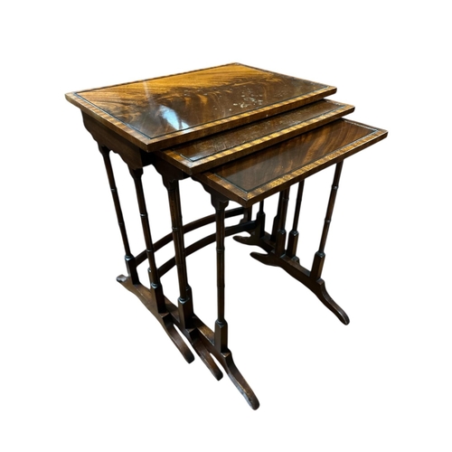 345 - A REGENCY STYLE MAHOGANY NEST OF THREE TABLES each of rectangular outline on dual ring turned suppor... 