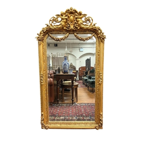349 - A CONTINENTAL GILT FRAME MIRROR the rectangular bevelled glass shaped plate within a foliate and flo... 