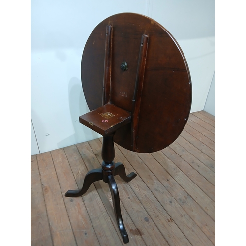 517 - A GEORGIAN STYLE MAHOGANY SNAP TOP TABLE the circular moulded top above a baluster column on tripod ... 