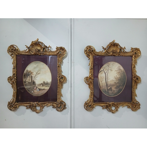 581 - A PAIR OF OVAL COLOURED PRINTS depicting figures in a landscape in ornate gilt frames 
86cm (h) x 66... 