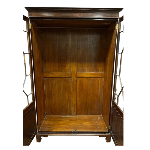 98 - A VINTAGE MAHOGANY DIAMOND DOOR WARDROBE the dentil moulded cornice above a pair of astragal glazed ... 