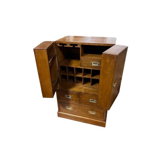 497 - A FINE WALNUT AND BRASS BOUND CAMPAIGN STYLE DRINKS CABINET of rectangular form the shaped top above... 