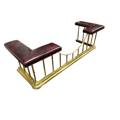 522 - A FINE VICTORIAN STYLE BRASS CLUB FENDER the L-shaped hide upholstered seats joined by a U-shaped st... 