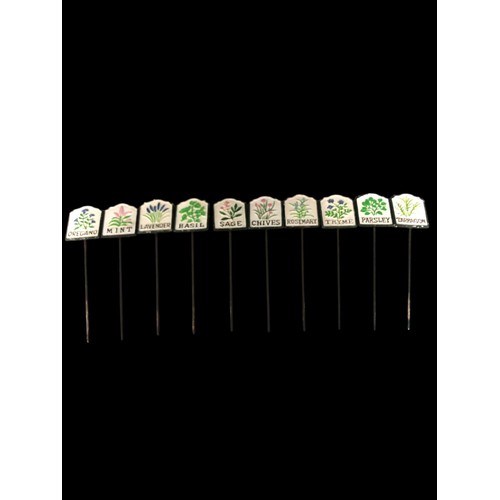 719 - A SET OF TEN CAST IRON AND PAINTED HERB SIGNS inscribed 'Rosemary', 'Parsley', 'Mint', 'Basil', etc.... 