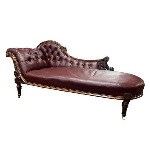402 - AN EDWARDIAN CARVED MAHOGANY AND HIDE UPHOLSTERED CHAISE LONGUE the shaped top rail with buttoned up... 