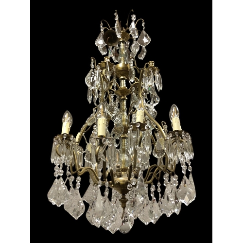317 - A FINE CONTINENTAL GILT BRASS AND CUT GLASS TWELVE BRANCH SIXTEEN LIGHT CHANDELIER the openwork fram... 
