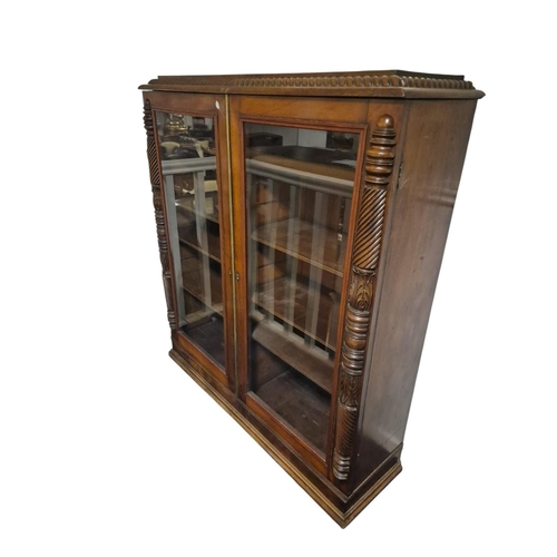 392 - A 19TH CENTURY MAHOGANY BOOKCASE of rectangular outline the shaped top with gadrooned rim above a pa... 