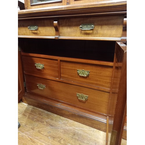 207 - AN EDWARDIAN SATIN BIRCH LIBRARY BOOKCASE the moulded cornice above three glazed doors containing ad... 