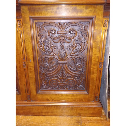 207 - AN EDWARDIAN SATIN BIRCH LIBRARY BOOKCASE the moulded cornice above three glazed doors containing ad... 