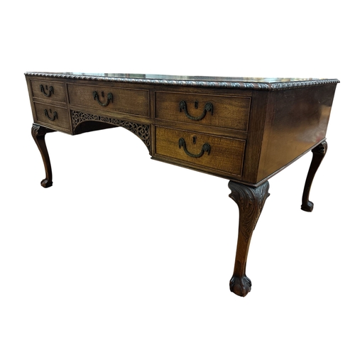 224 - A 19TH CENTURY CHIPPENDALE DESIGN PARTNERS' DESK the rectangular top with tooled leather inset and g... 