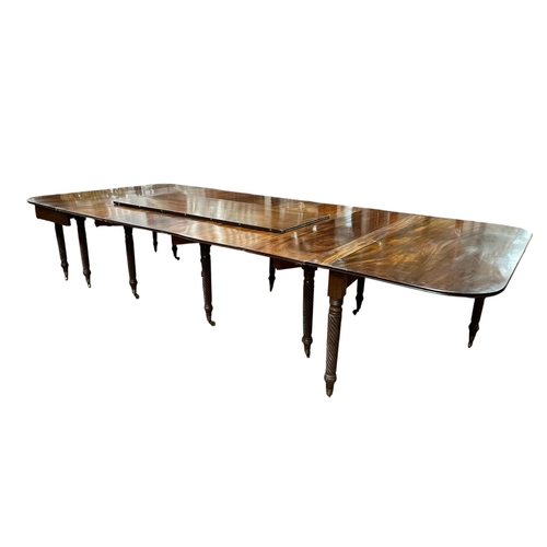 397 - A VERY FINE REGENCY MAHOGANY CONCERTINA ACTION EXTENDING DINING TABLE Cork c.1820, of rectangular fo... 