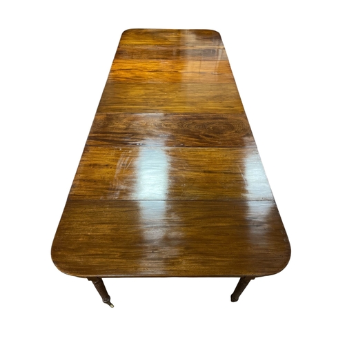 397 - A VERY FINE REGENCY MAHOGANY CONCERTINA ACTION EXTENDING DINING TABLE Cork c.1820, of rectangular fo... 