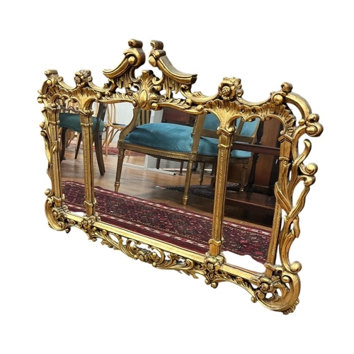 125 - A GILT FRAME COMPARTMENTED MIRROR the rectangular plates within a pierced foliate and flowerhead fra... 