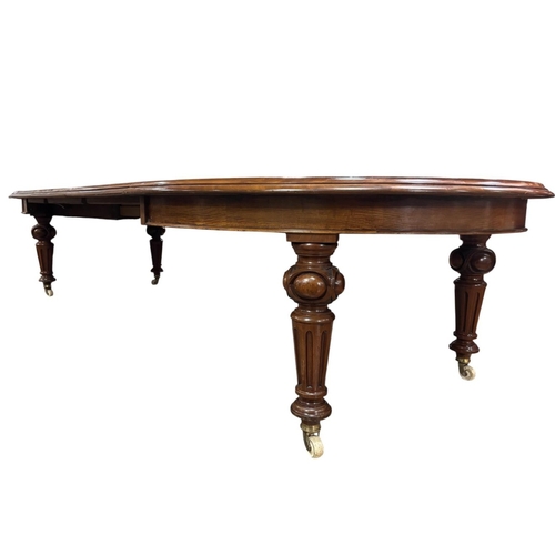 A FINE 19TH CENTURY MAHOGANY TELESCOPIC DINING TABLE of rectangular outline with rounded ends and three loose leaves on fluted lobed and turned legs with brass and porcelain castors 75cm (h) x fully extended 346cm (l) x 137cm (d) Two loose leave 60cm (w), One leaf 43cm (w)