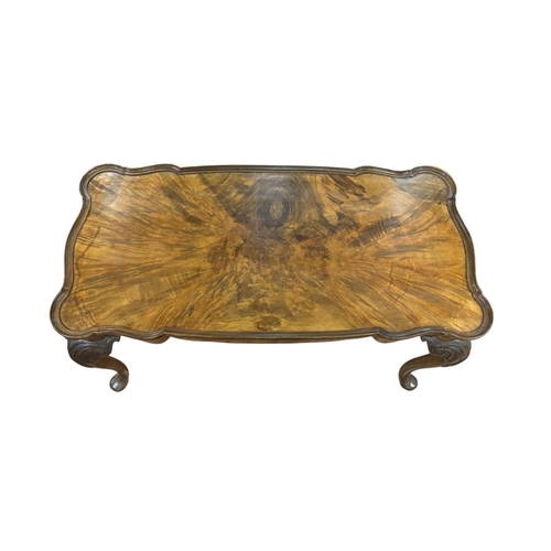 225 - A VINTAGE WALNUT AND MAHOGANY COFFEE TABLE of rectangular shaped outline the dish shaped top raised ... 