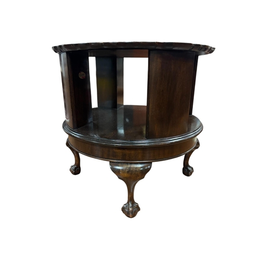 367 - A VINTAGE MAHOGANY REVOLVING TABLE the circular piecrust top above open compartments on a revolving ... 