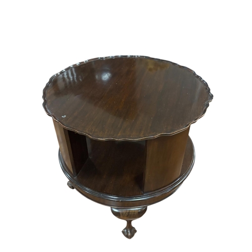 367 - A VINTAGE MAHOGANY REVOLVING TABLE the circular piecrust top above open compartments on a revolving ... 