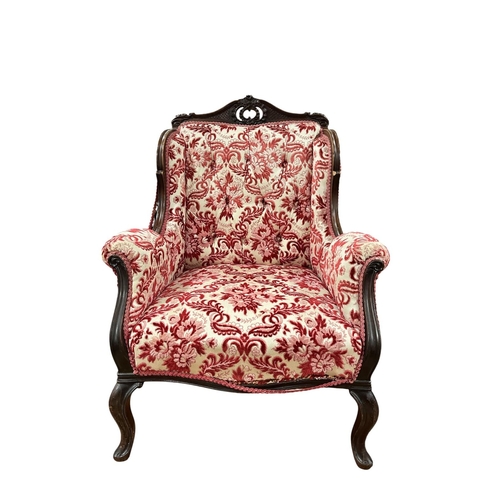 189 - AN EDWARDIAN CARVED MAHOGANY AND UPHOLSTERED ARMCHAIR the pierced top rail with buttoned upholstered... 