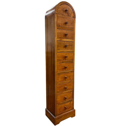 192 - A HARDWOOD TEN DRAWER TALLBOY of rectangular arched form on platform support 140cm (h) x 29cm (w) x ... 