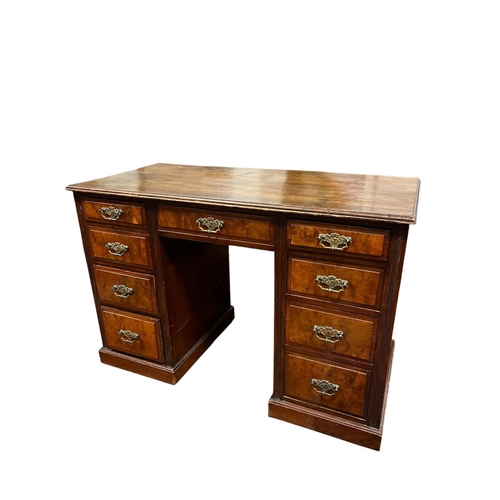196 - AN EDWARDIAN MAHOGANY AND WALNUT PEDESTAL DESK the rectangular shaped top with frieze drawer flanked... 