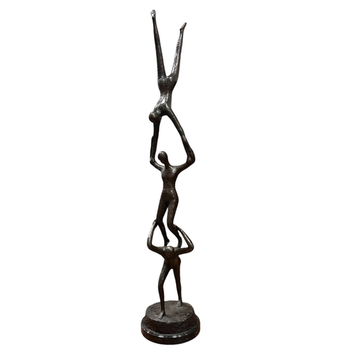 198 - after LARSON A cast bronze sculpture modelled as three acrobats, signed, raised on a black veined ci... 