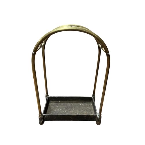 200 - A 19TH CENTURY BRASS COMPARTMENT STICK STAND of rectangular arched form with cast iron well 58cm (h)... 