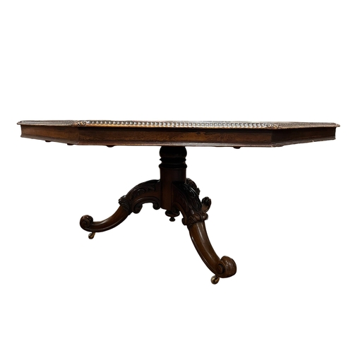 226 - A 19TH CENTURY ROSEWOOD POD TABLE of octagonal form the shaped top above a baluster column on carved... 