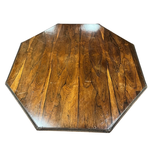 226 - A 19TH CENTURY ROSEWOOD POD TABLE of octagonal form the shaped top above a baluster column on carved... 