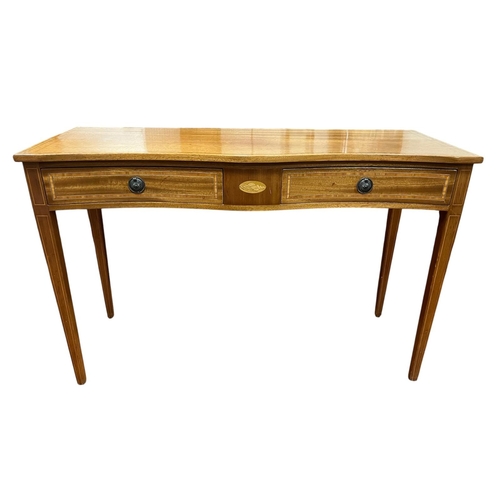 234 - A SHERATON STYLE MAHOGANY AND SATINWOOD INLAID CONSOLE TABLE of serpentine outline the shaped top ab... 