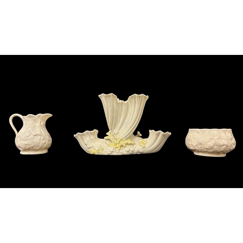 279 - THREE PIECES OF BELLEEK comprising a second period triple bud vase 12cm (h), a fourth period creamer... 