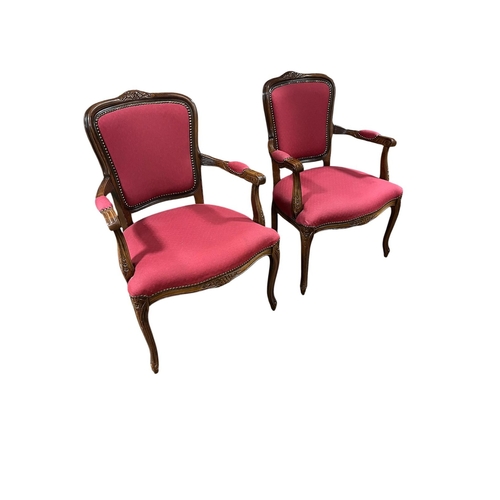 368 - A PAIR OF CONTINENTAL STAINED WOOD AND UPHOLSTERED SALON CHAIRS each with a foliate carved top rail ... 