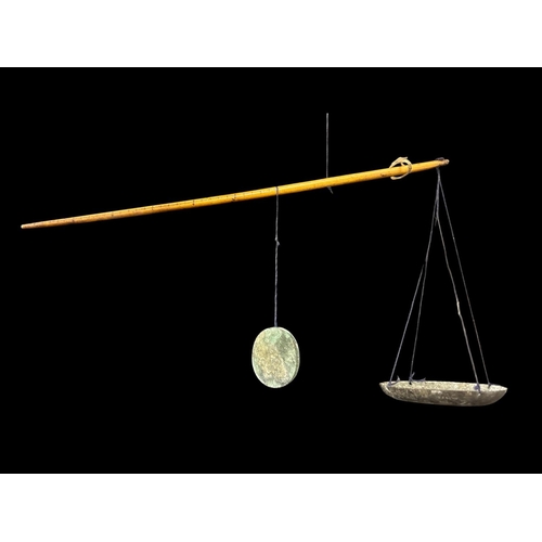 485 - AN ANTIQUE CHINESE DACHING WEIGHING SCALES constructed of a tapering bone beam with two sets of mark... 