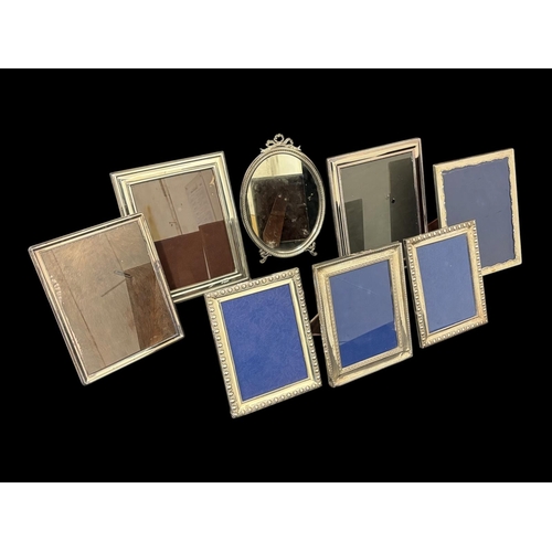 487 - SEVEN STERLING SILVER MOUNTED TABLE TOP PICTURE FRAMES Largest 30cm (h) x 24cm (w) together with a s... 