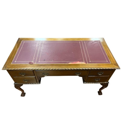 72 - A CHIPPENDALE STYLE MAHOGANY DESK of rectangular outline the shaped top with tooled leather inset an... 