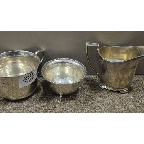 255 - A STERLING SILVER SUGAR BOWL Birmingham 1939 together with a sterling silver cream jug Sheffield 193... 